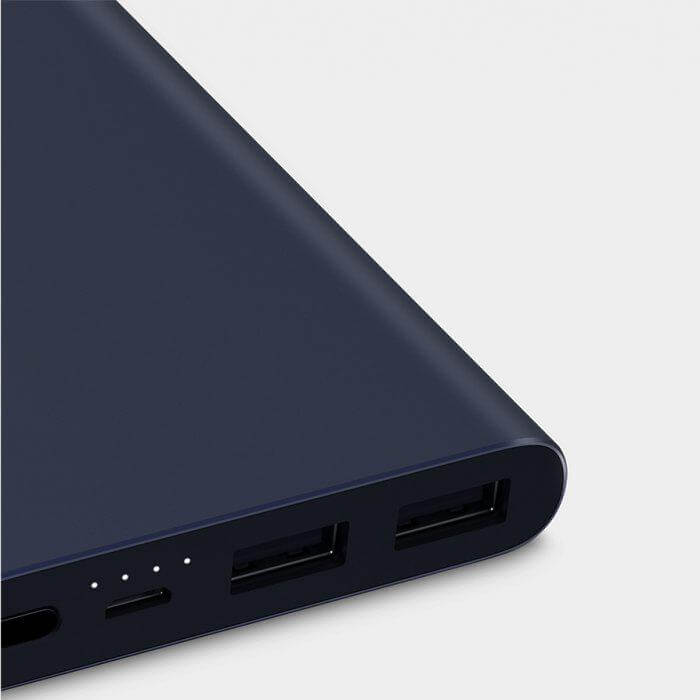 Close-up of the dark blue Xiaomi power bank end panel with two USB-A ports and battery indicator lights
