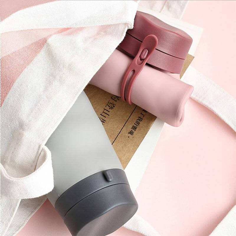 BPA Free Foldable Travel Bottle in a stylish tote bag, eco-friendly and portable for hydration on the go.