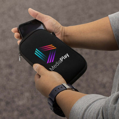 Person holding a Spencer Phone Sleeve with MediaPlay logo, showcasing its sleek design and padded protection.