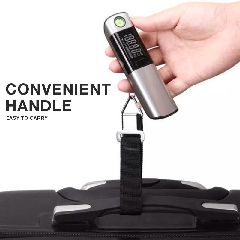 Hand holding the digital luggage scale with its black strap looped around a suitcase handle