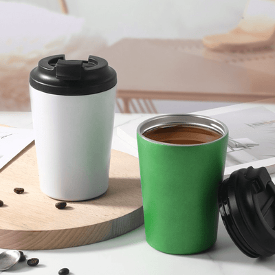 Stainless Steel 350ml Vacuum Mug in white and green on a wooden table with coffee beans.