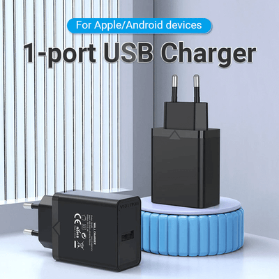 Vention 1-Port USB Wall Charger 12W on a table, ideal for charging Apple and Android devices efficiently.