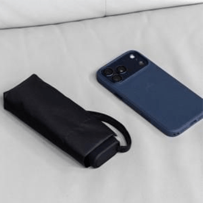 Brand Charger Vireo Mini Umbrella next to a smartphone on a couch, showcasing portable design.