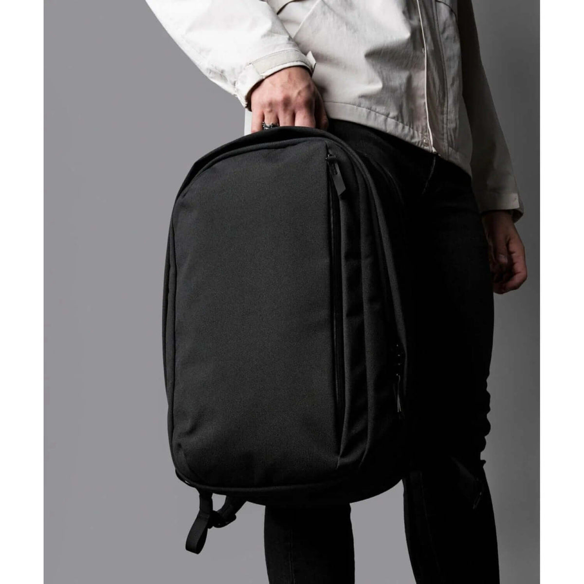 Person holding the ALPAKA Metro Backpack Pro in black for modern professionals, ideal as a corporate gift.