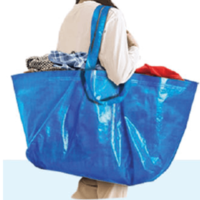 A woman carrying a blue Laundry Carrier Bag filled with clothes, showcasing its practicality and spacious design.