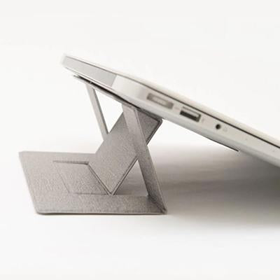 Side close-up of the grey stand’s triangular folded support beneath an elevated silver laptop