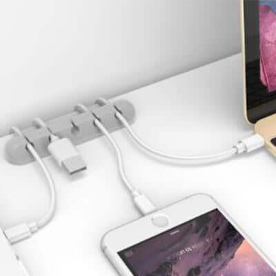 Desk Silicone Wire Organizer holds cables neatly on a workspace, perfect as a Corporate Gift Singapore.