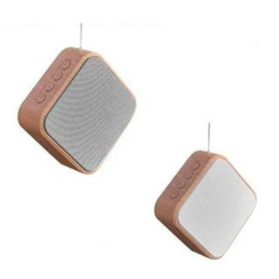 Rounded rectangular speakers with wood-look surrounds, grey and pale front grilles, side controls and projecting antennas