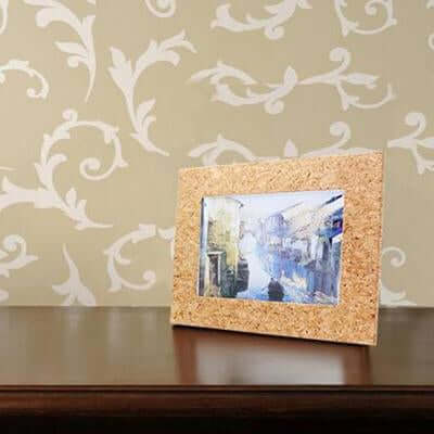 Eco-friendly Cork Wooden Photo Frame displaying a beautiful painting on a stylish table against elegant wallpaper.