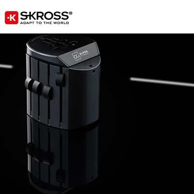 Black SKROSS Alpha travel adaptor standing upright with side selector sliders and its top socket visible.