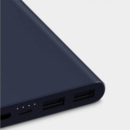 Close-up of the dark blue Xiaomi power bank end panel with two USB-A ports and battery indicator lights