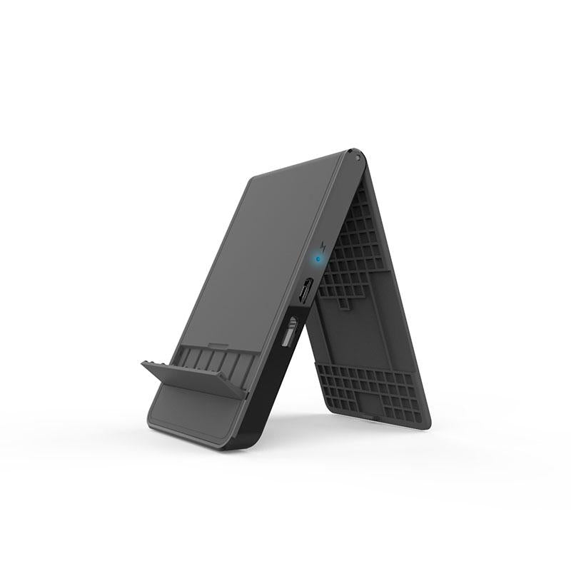 Black folding wireless charging phone stand opened upright, showing support ledge, side port and blue indicator.