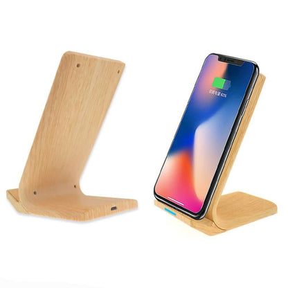 Light wood-look wireless charging stand shown empty and supporting a phone in portrait orientation