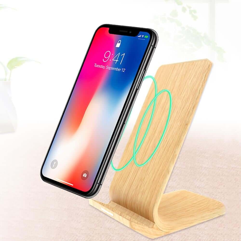 Wood-look wireless charging stand with phone in portrait position and illustrative charging-coil graphic