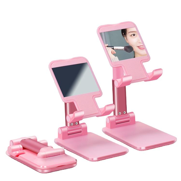 Pink folding phone stand shown in adjustable viewing positions and folded for storage