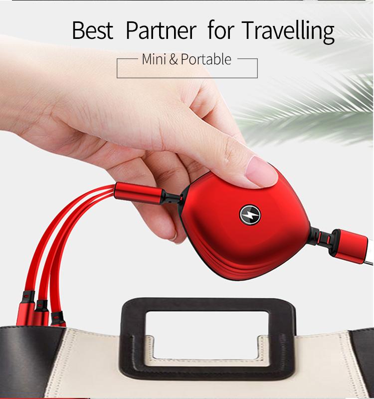Red retractable three-in-one cable held above a bag to show its rounded housing and short connector leads