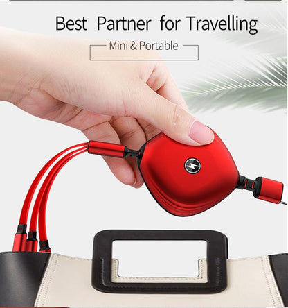 Red retractable three-in-one cable held above a bag to show its rounded housing and short connector leads