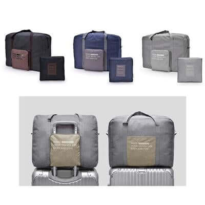 Dark, navy and grey folding travel bags with compact packs, plus a grey bag shown over a suitcase handle