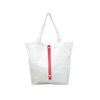 Natural-coloured canvas tote bag with long handles and a red vertical fastening strap