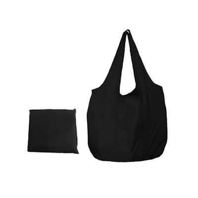Black foldable nylon tote with two handles beside a compact matching pack