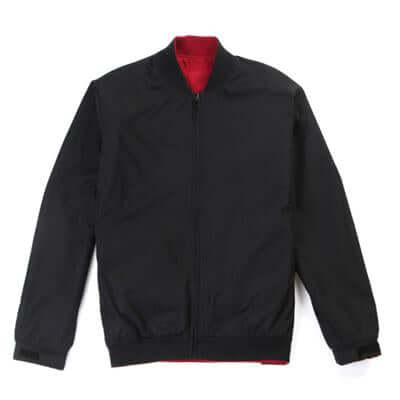 Black bomber jacket laid flat with contrasting red inner collar