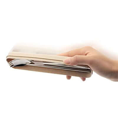 Hand holding a closed beige travel cutlery case