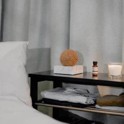 Zero2.5 Natural Fiber-based Negative Ionizer Air Marble CF4000 on bedside table with essentials.