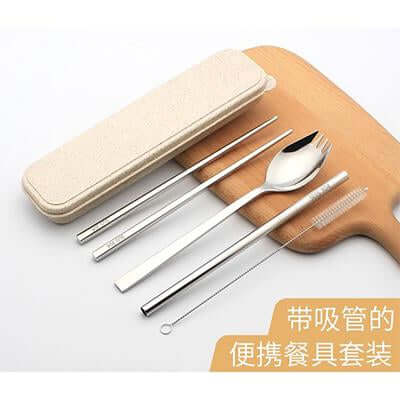 Metal travel utensils and beige case arranged on a wooden board