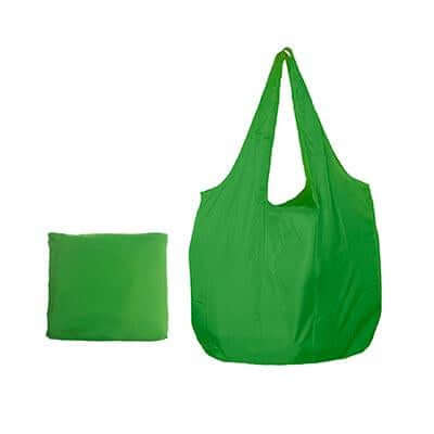 Green foldable nylon tote with two handles beside a compact matching pack