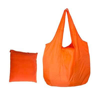 Orange foldable nylon tote with two handles beside a compact matching pack