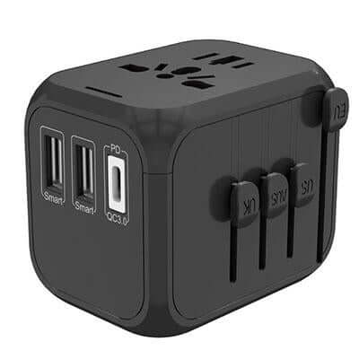 Black world travel adaptor showing top AC socket, two USB-A ports, Type-C port and sliding plug selectors